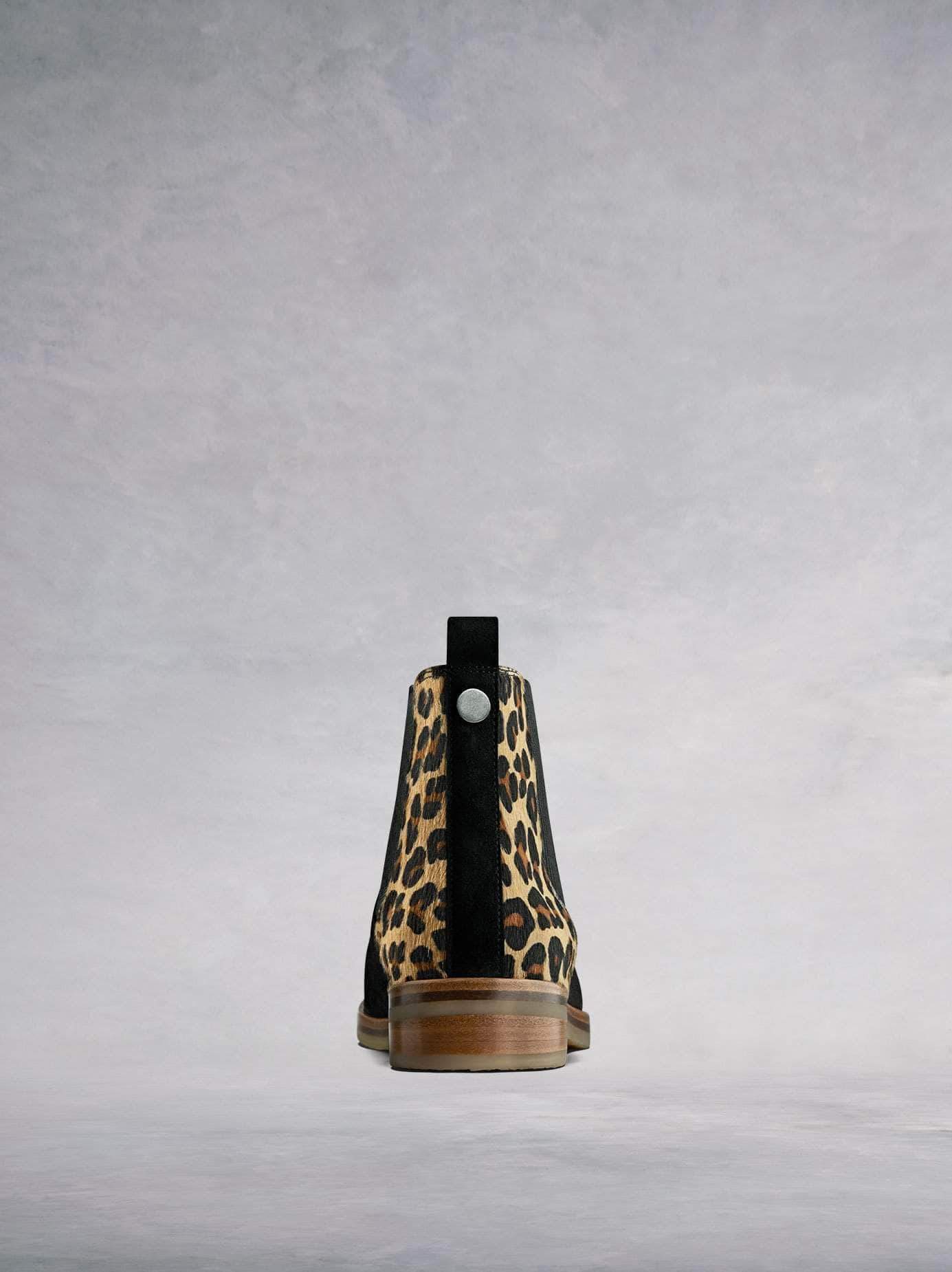 The back features luxurious leopard print pony hair and a pull-tab.
