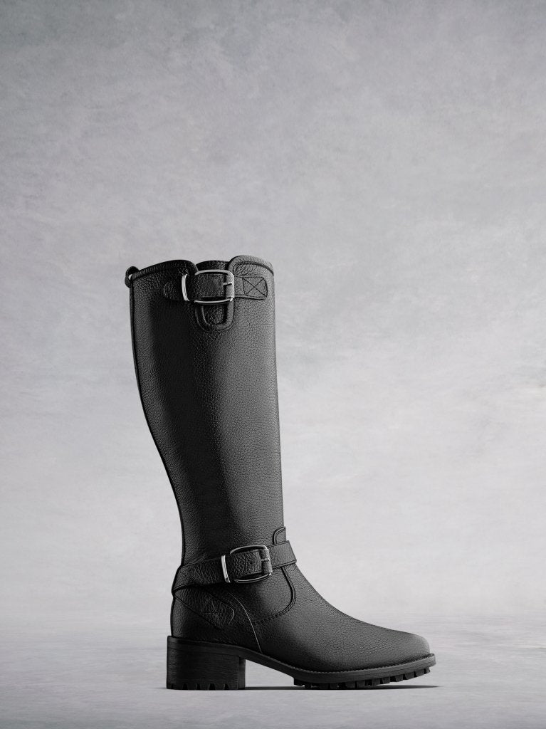The Demeter; a knee high textured black leather biker boot with buckles.