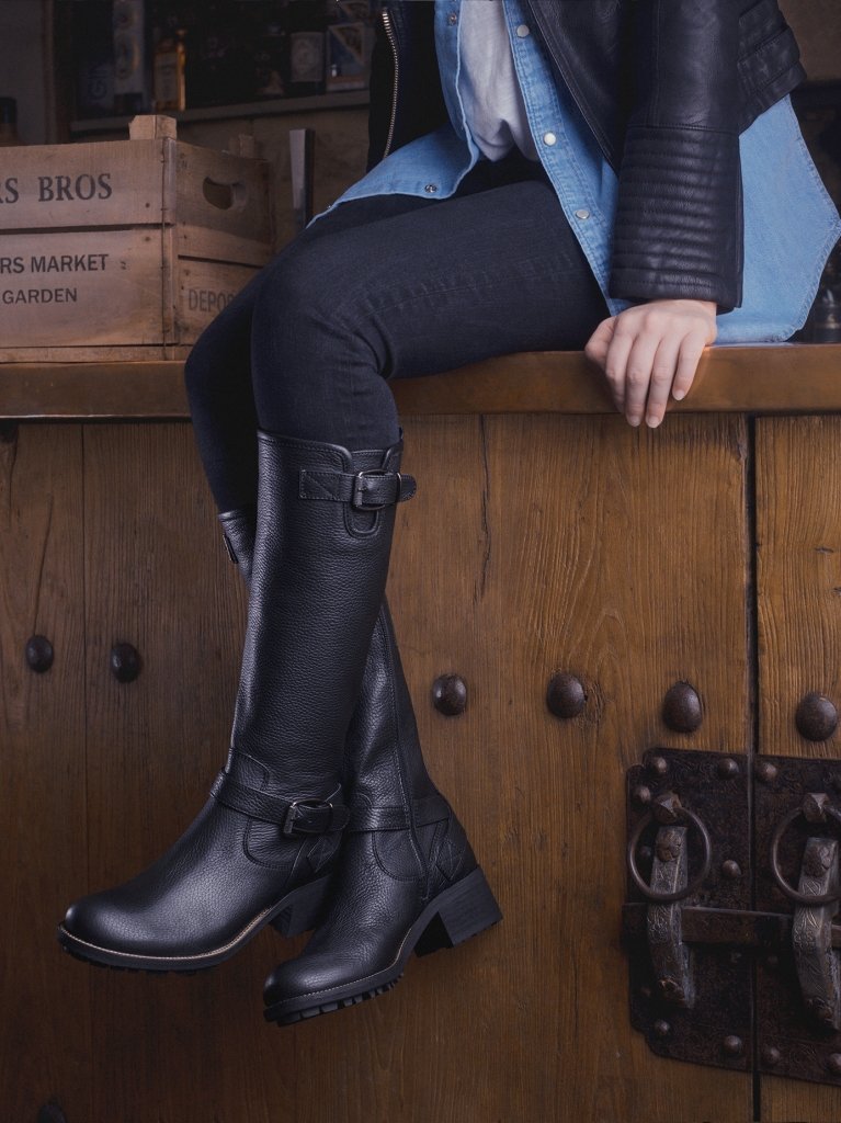 Detailed with a buckle strap, stud trims and a heavy tread sole.