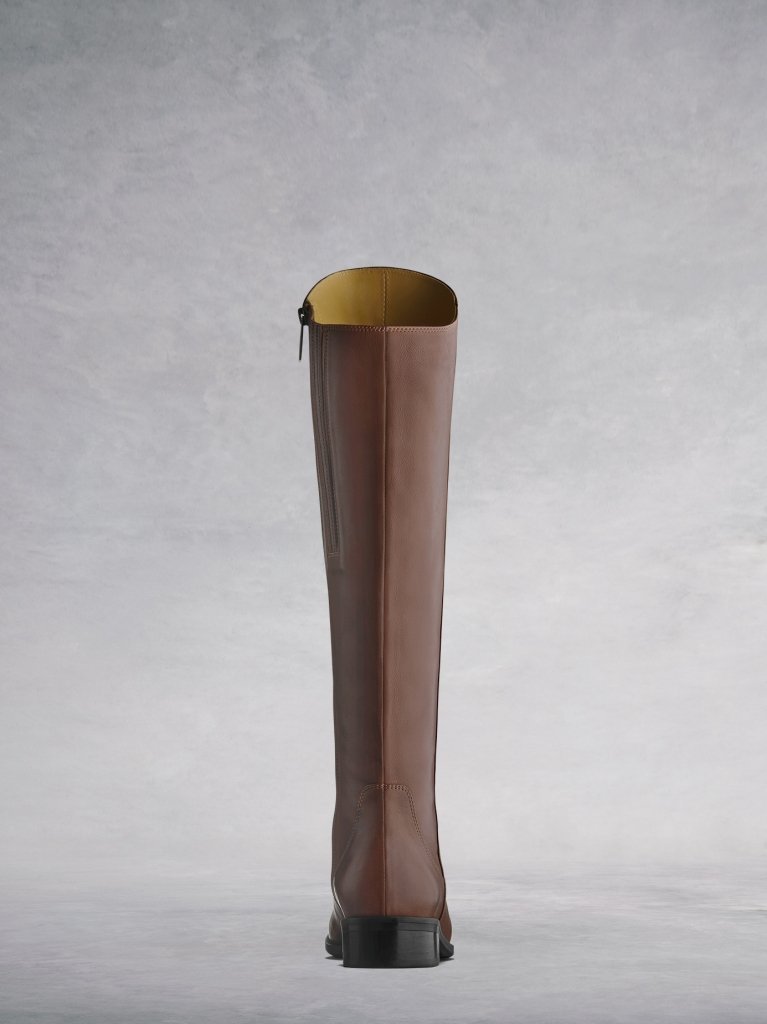 The tan Huntsman has a lower asymmetric cut at the back of the boot.