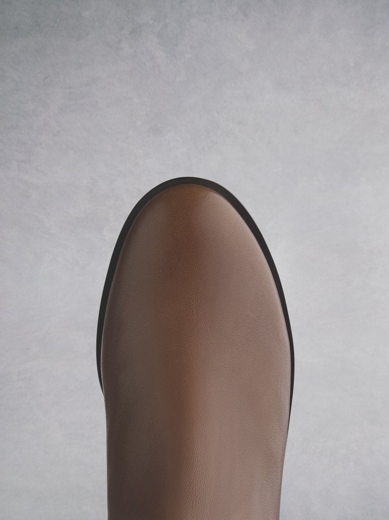 Featuring a tan leather round toe that looks both elegant and classic.