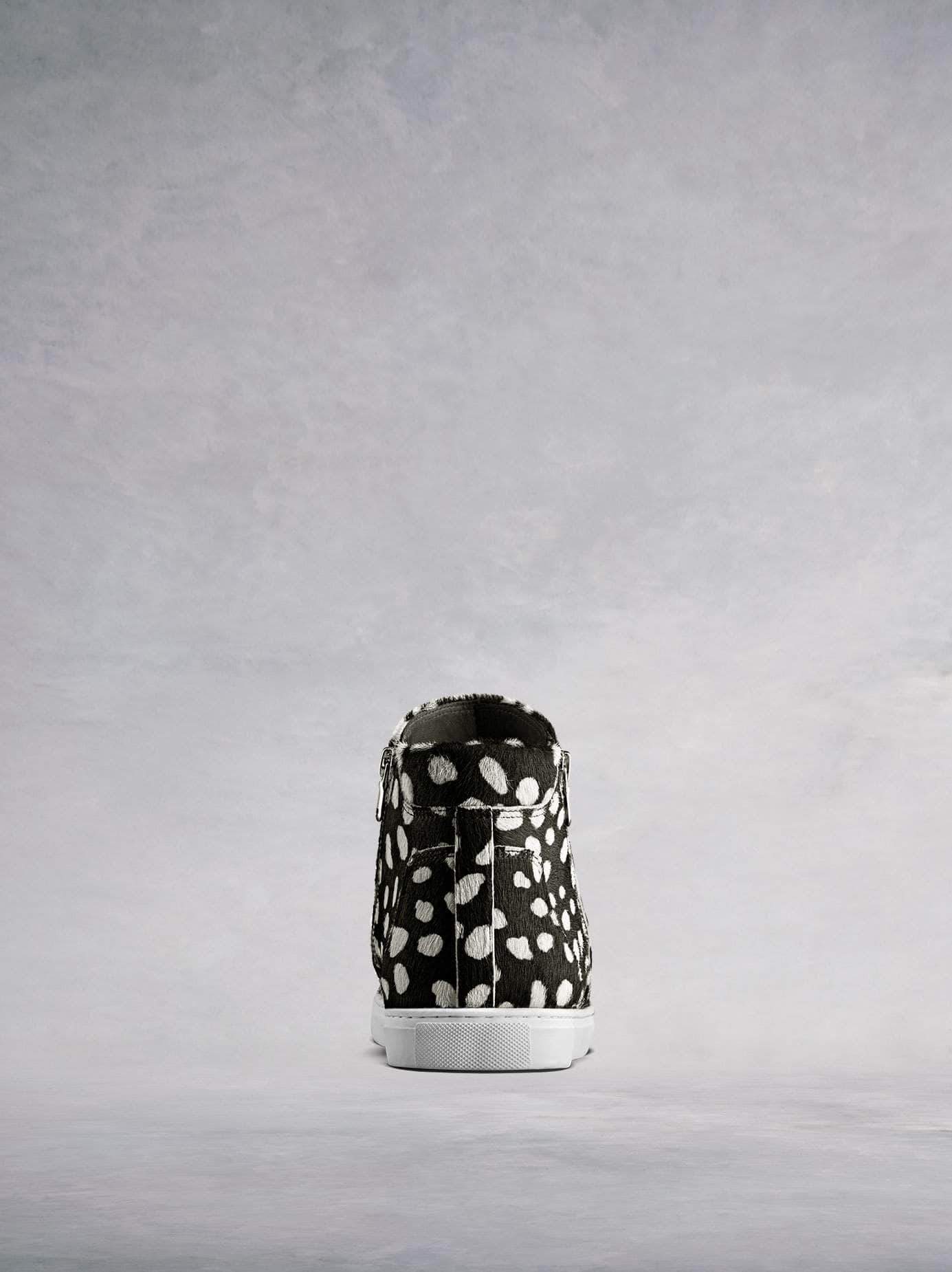 Made from stylish black and white hair leather with a contrast white sole.