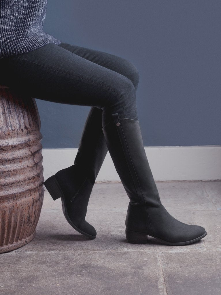 The staple black boot has a curved topline - both stylish and practical.