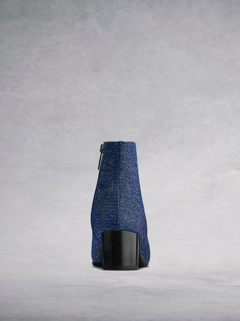 The blue boot features a contrasting black square shaped low block heel.