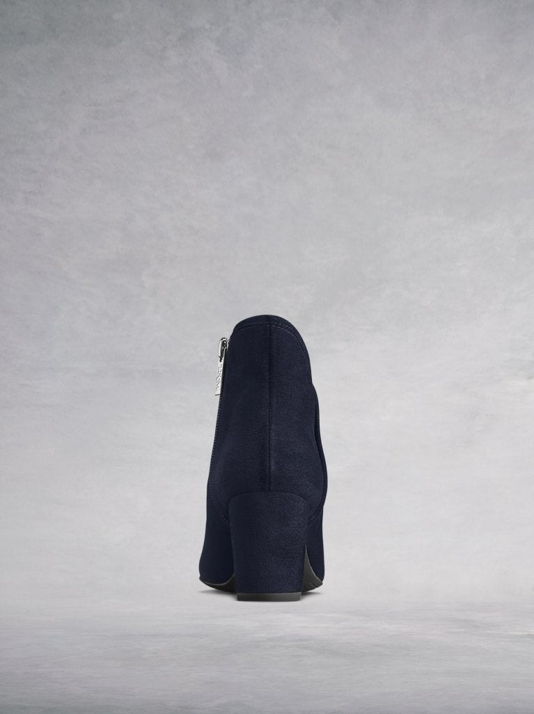 The back features a navy suede covered mid-height block heel.
