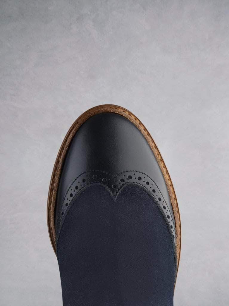 Featuring traditional brogue detailing over a round toe shape.