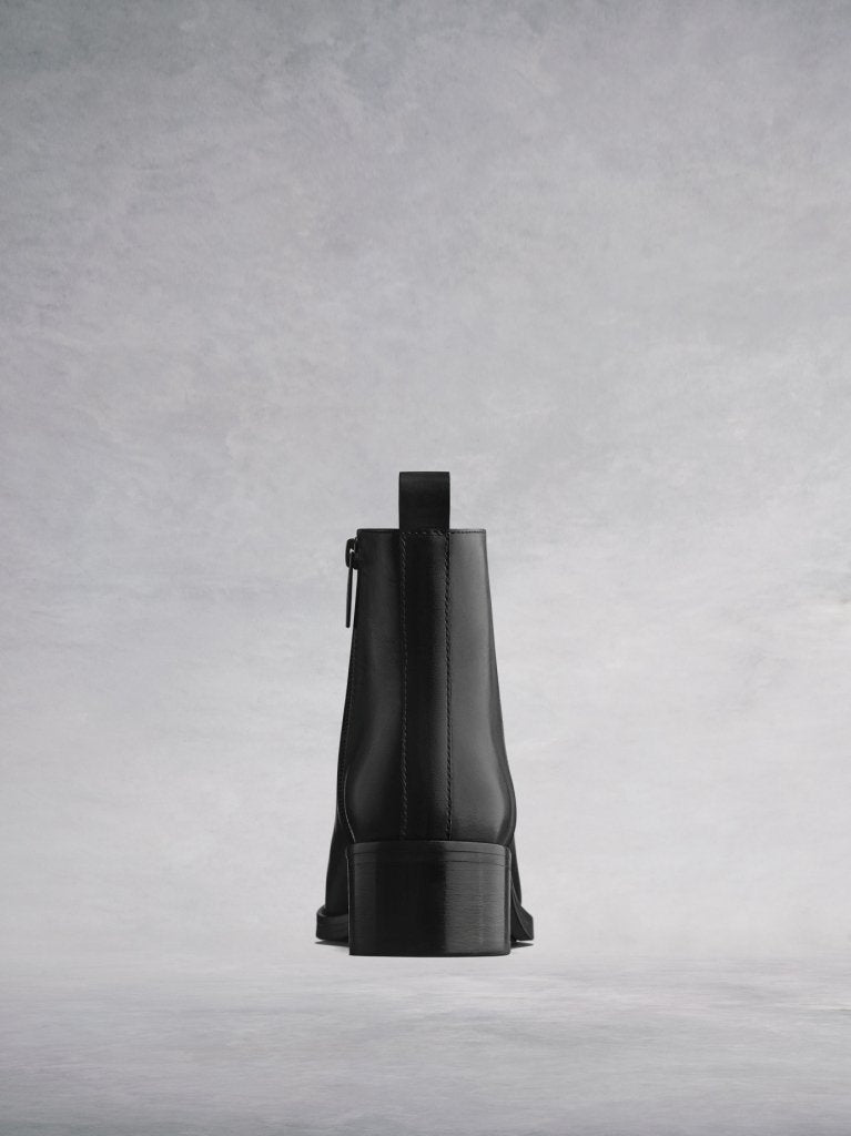 A versatile black ankle boot with a low black block heel.