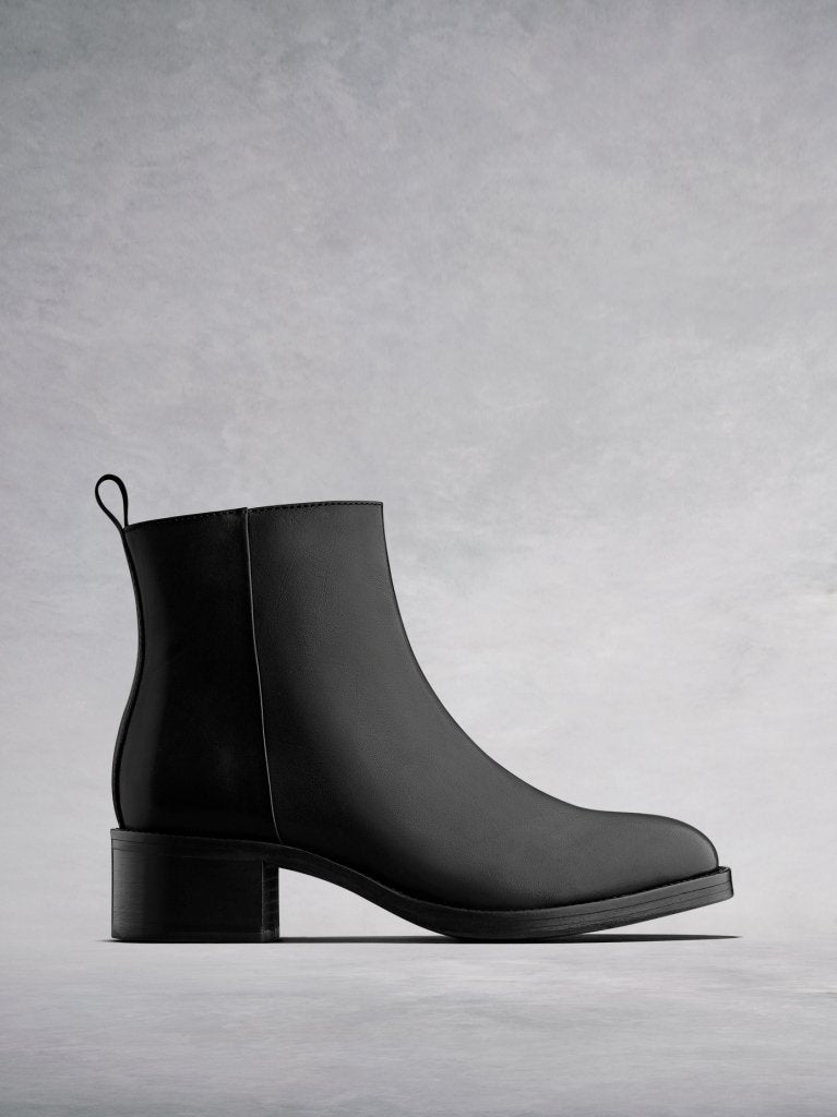 Arietty, a timeless black leather ankle boot with a classic silhouette. 