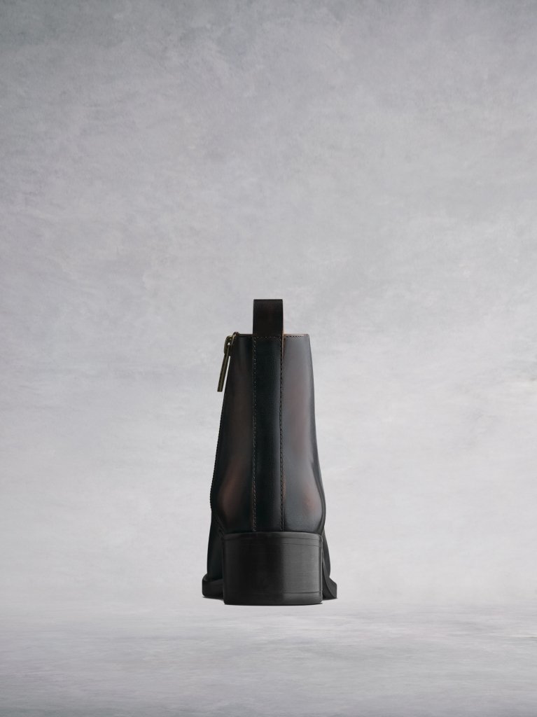 A versatile brown ankle boot with a low black block heel.