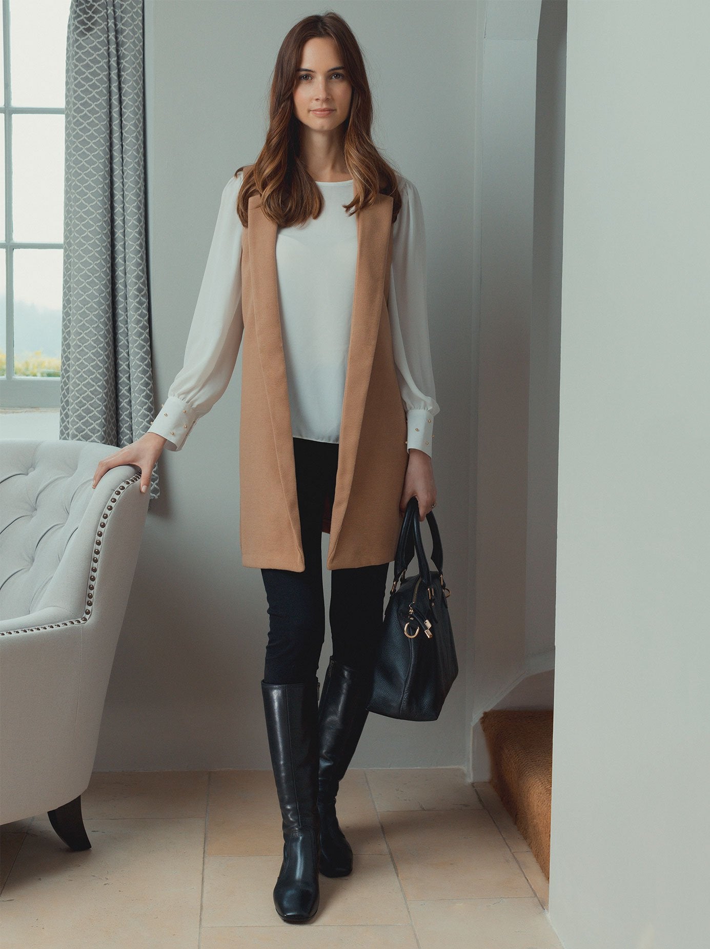Sleek leather brown boot with double stitched detailing to enhance silhouette. 
