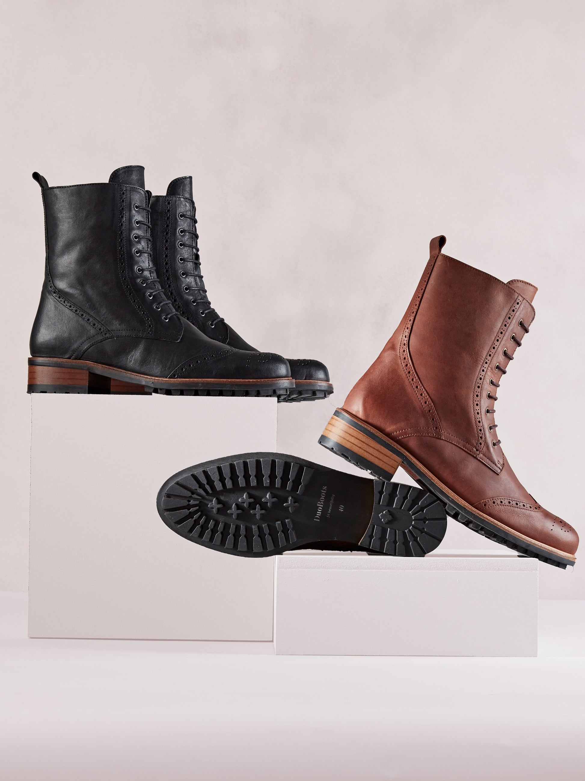 Black leather ankle boots with brogue detailing and a leather trim around the fashionable rubber tread sole.