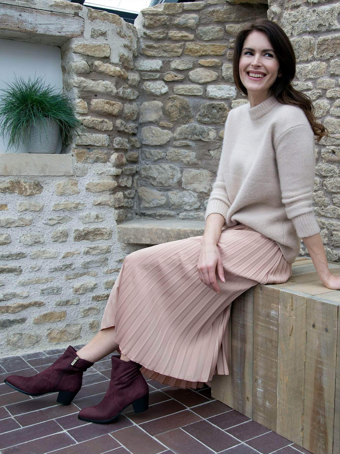 Luxury ankle boot in burgundy nubuck leather with intricate stitch and stud detailing. 