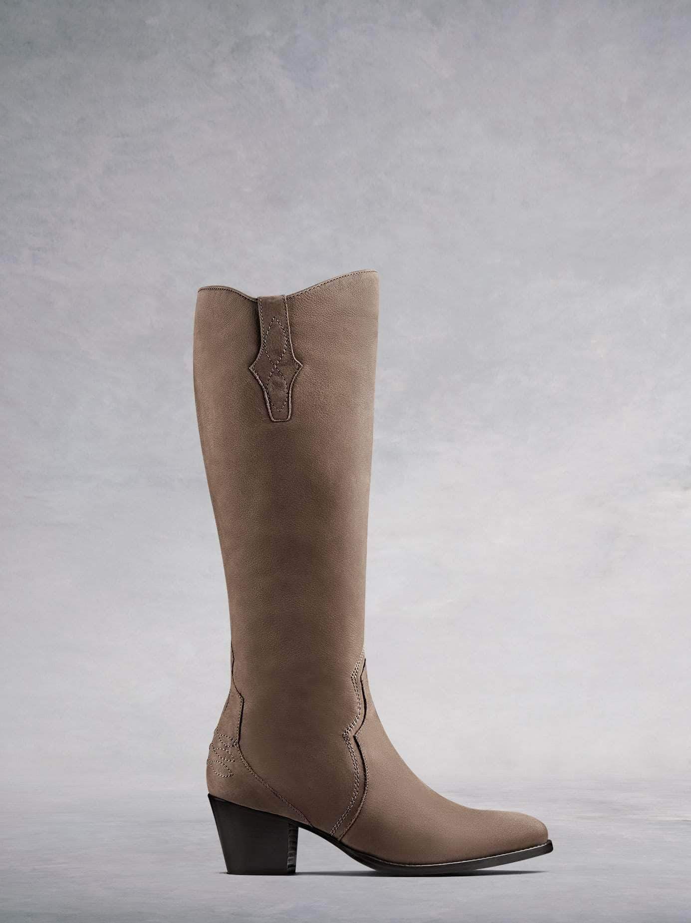 Buckland, our elegant Western-inspired knee high boot crafted from taupe nubuck leather with intricate detailing. Available in a wide range of calf sizes.
