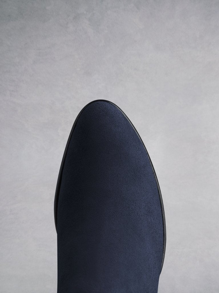 Buell navy features an almond toe shape, offset by a unique angular heel.
