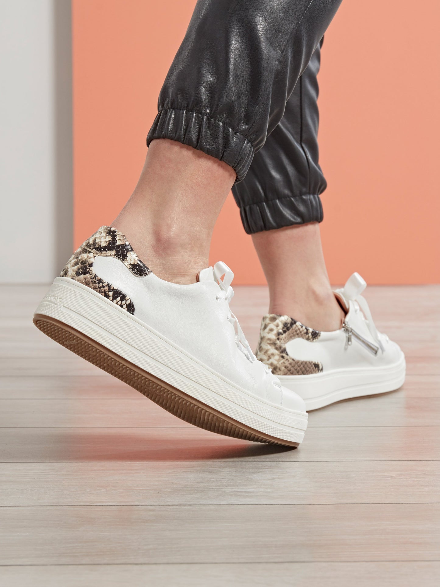Churston, a trend-led flatform white trainer with a snake printed leather heel.