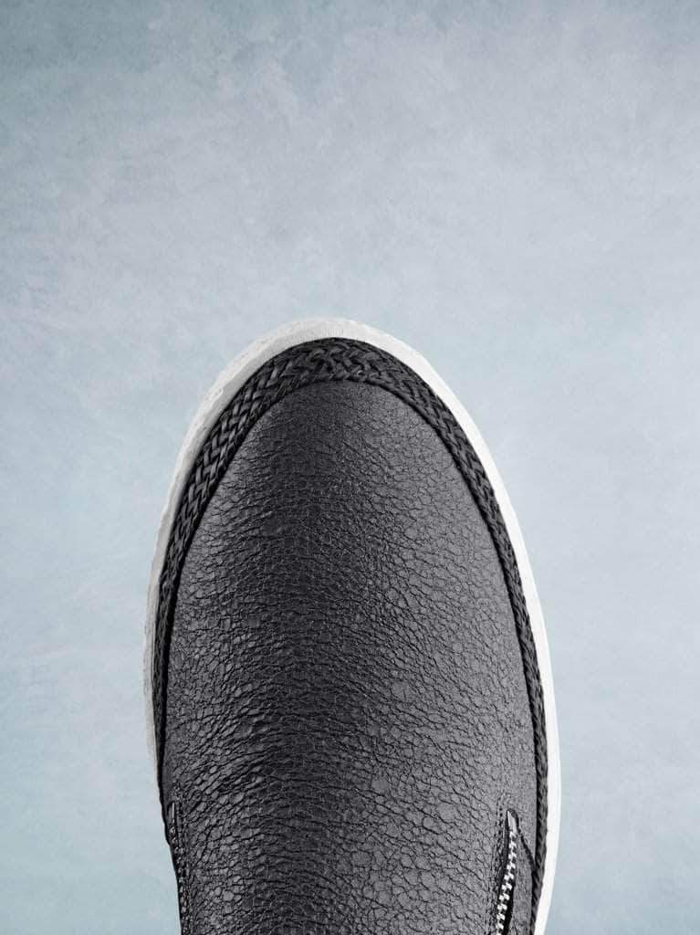 This easy-to-wear trainer has a smooth round toe with a contrasting lace trim. 
