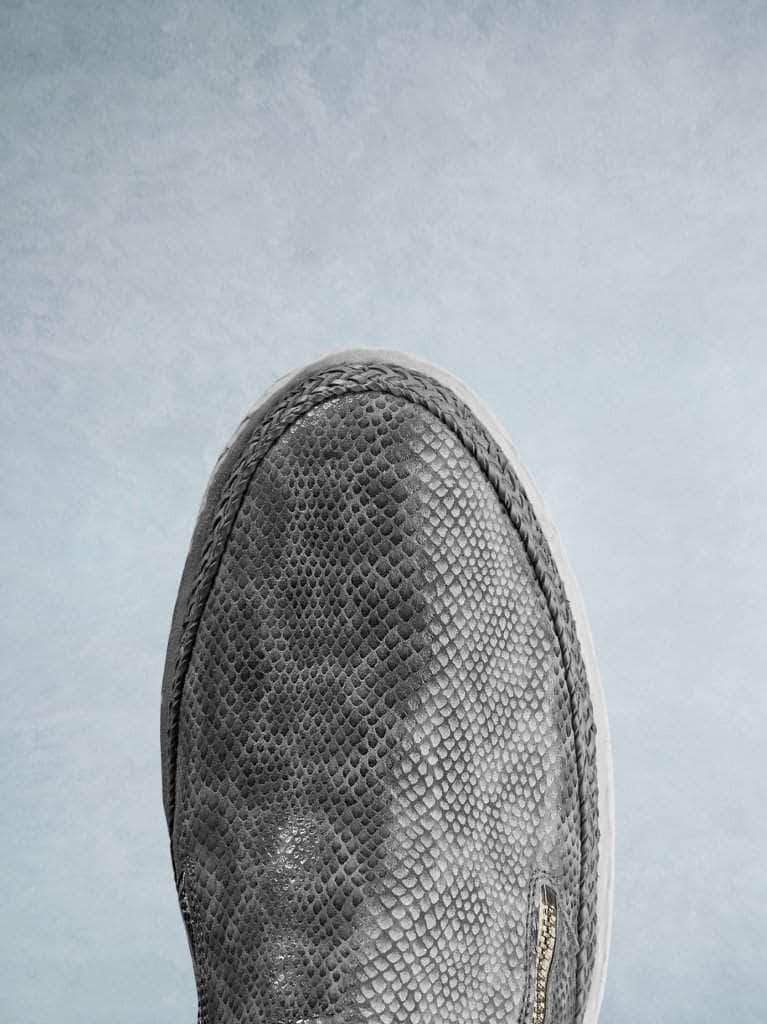 This easy-to-wear trainer has a smooth round toe with a contrasting lace trim. 