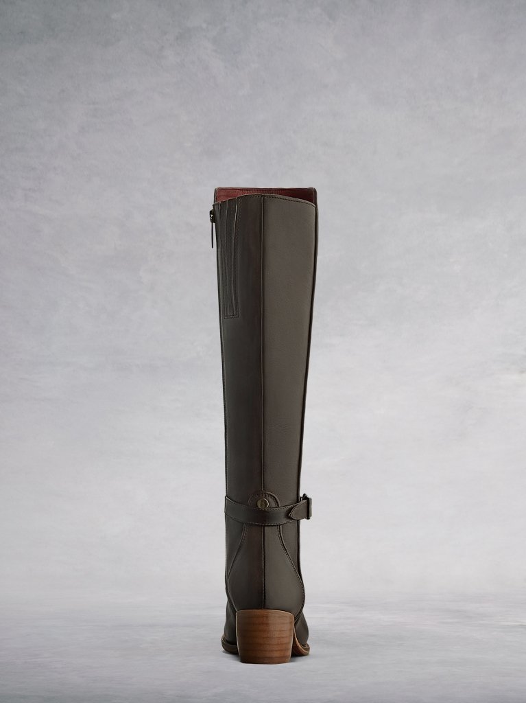 The brown back features a stacked wooden heel, ankle strap and metal stud.