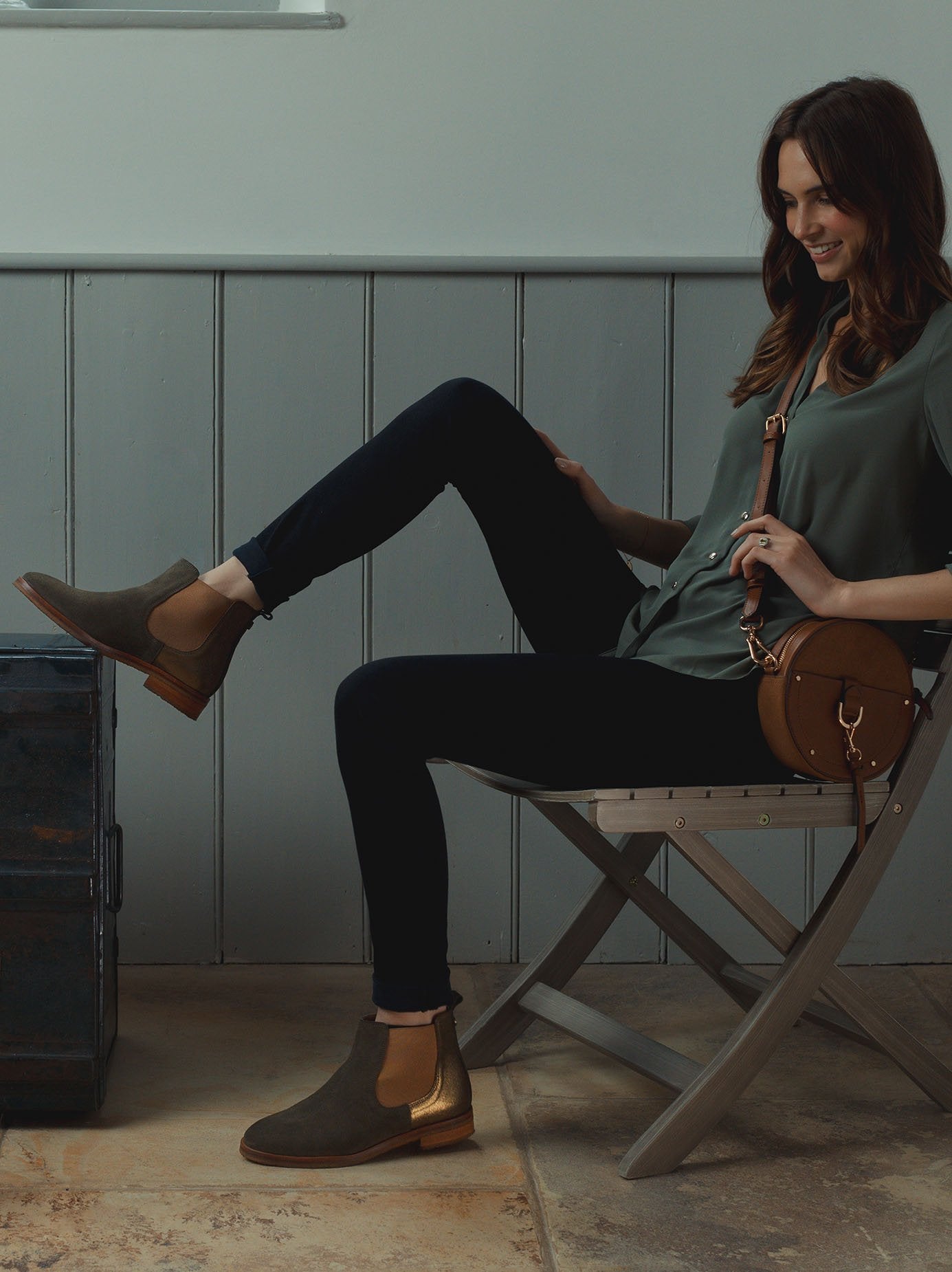 The khaki ankle boot is contrasted by the ribbed tan elastic panel.