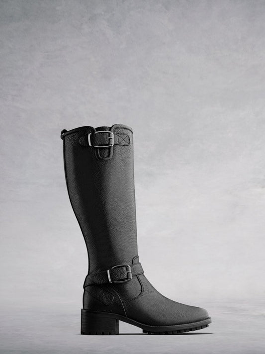The Demeter; a knee high textured black leather biker boot with buckles.