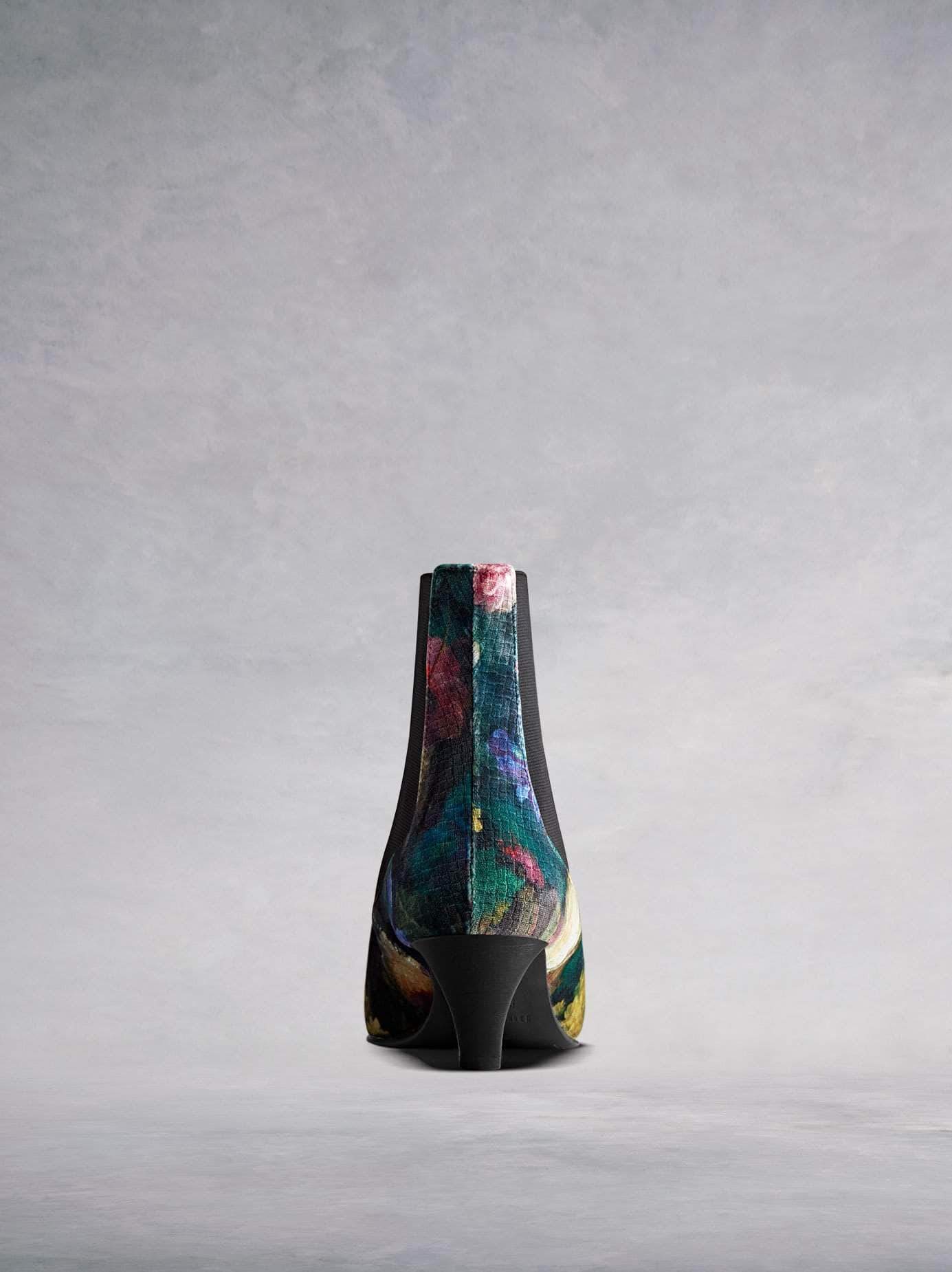 This velvet ankle boot features a slim, square shaped, low Italian heel. 