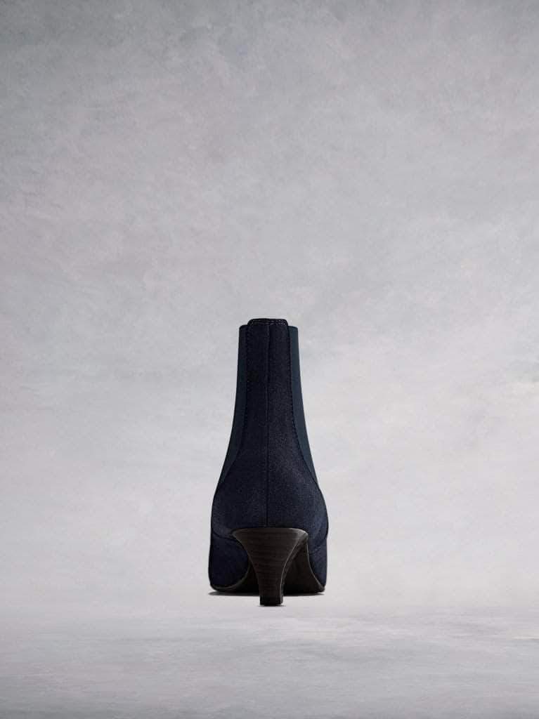 This navy ankle boot features a slim, square shaped, low Italian heel. 