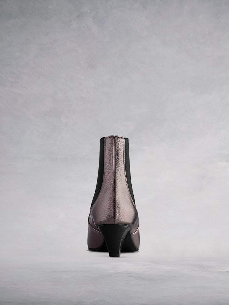 This pewter ankle boot features a slim, square shaped, low Italian heel. 