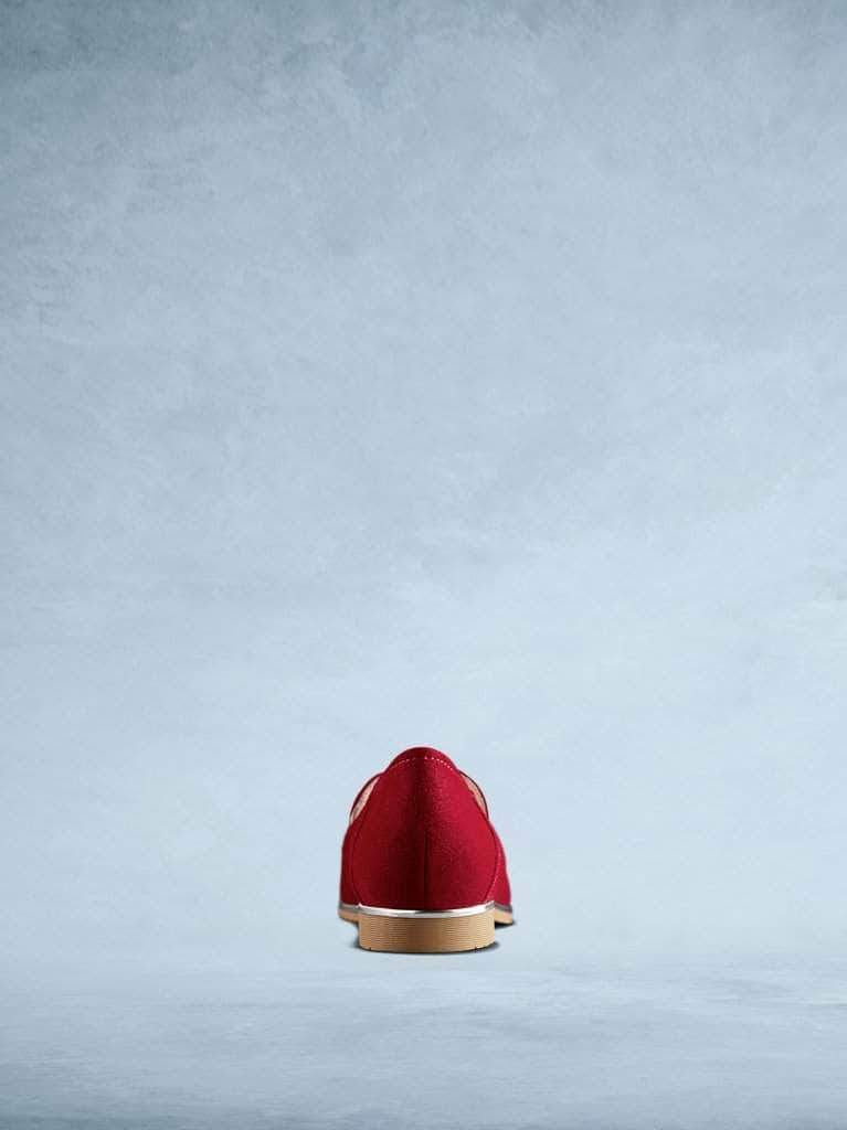 This red suede pump has a contrast light brown sole. 