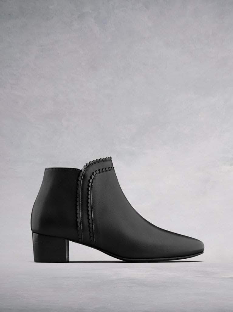 Florencia, our black leather ankle boot with a scalloped edged trim. 