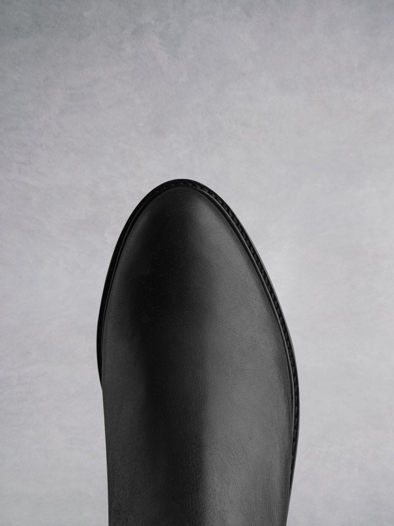 This boot has a sleek finish with an almond shaped toe. 