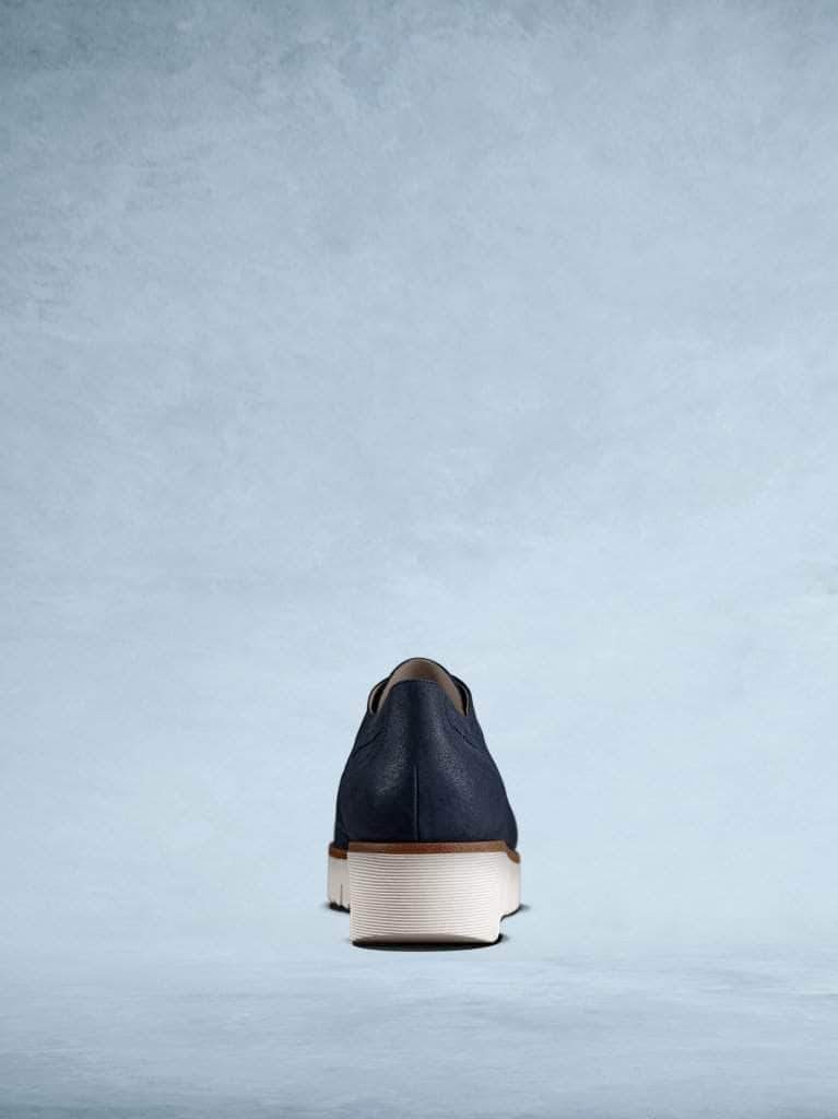 This back of the trainer features flattering navy brogue detailing.