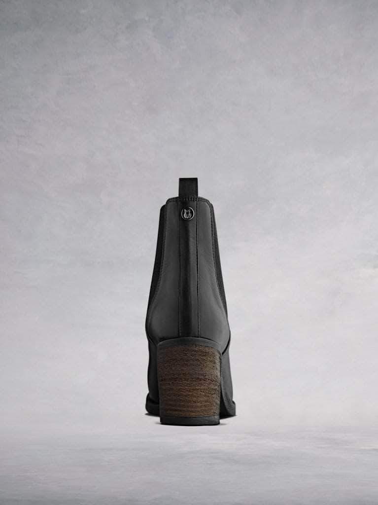 With a stacked leather veneer around a block heel with a black rubber sole.