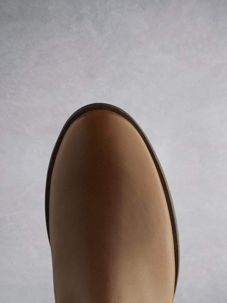 This tan ankle boot with a round toe shape, that complements the block heel. 