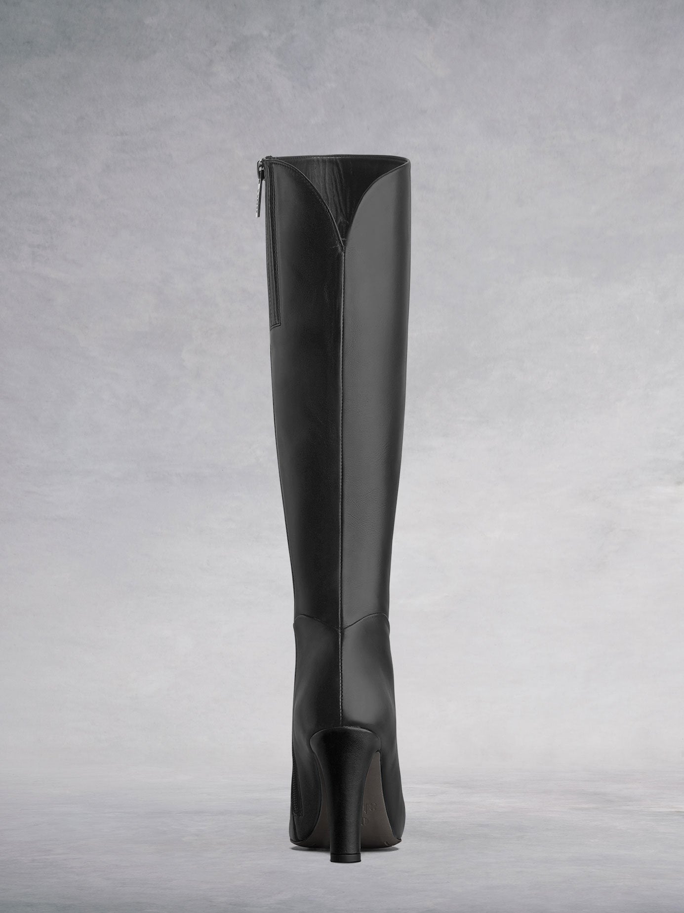 The black leather sweetheart topline complements the curved ankle seam.