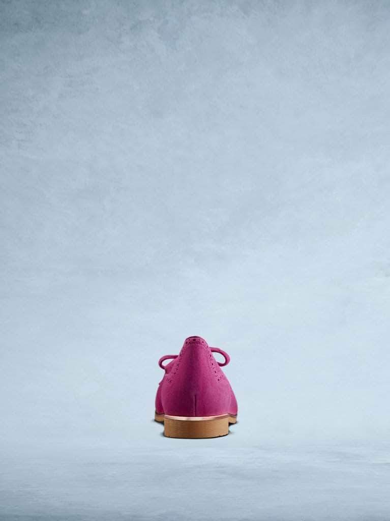 Lamorna pink suede features subtle brogue detailing and a contrasting metallic trim. 
