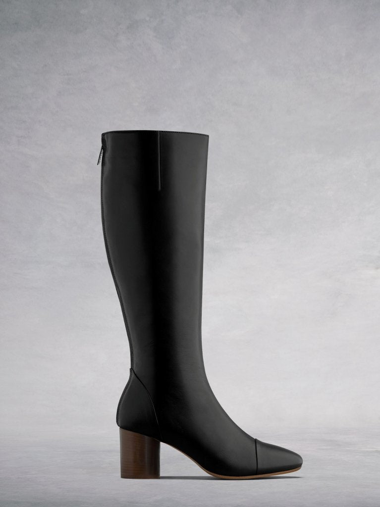 The Langley, a black leather knee high boot with luxe burgundy lining.