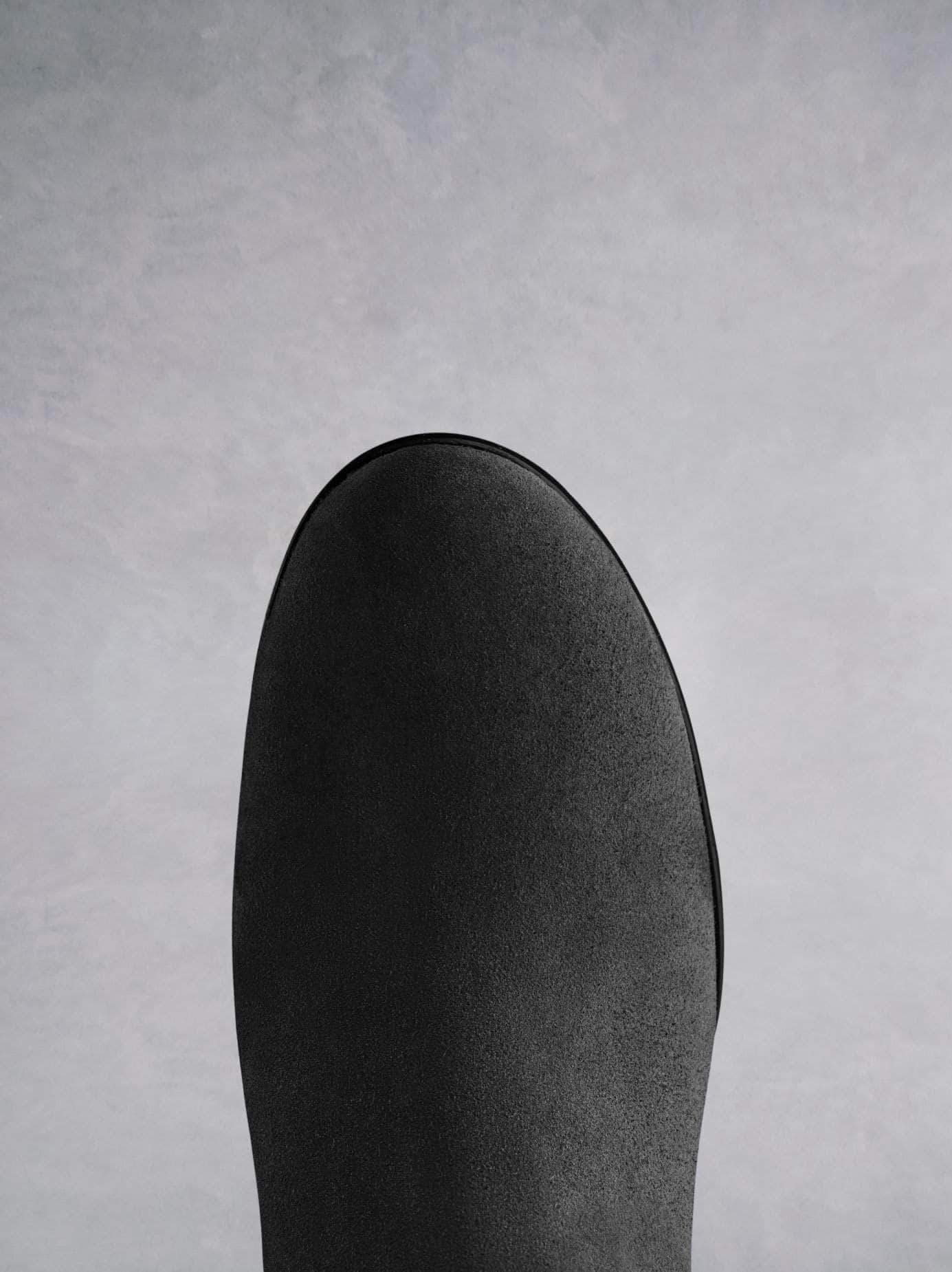 This black suede ankle boot has a comfortable round toe shape.