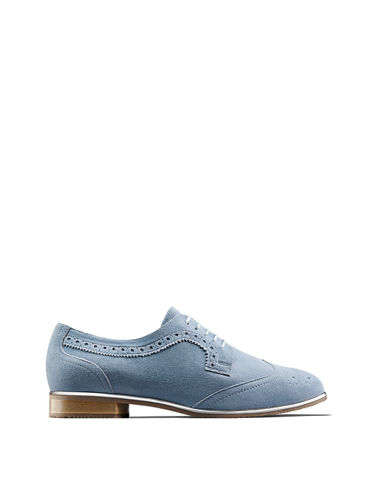 Mullion in chambray blue suede, a brogue shoe with a metallic gun metal trim.