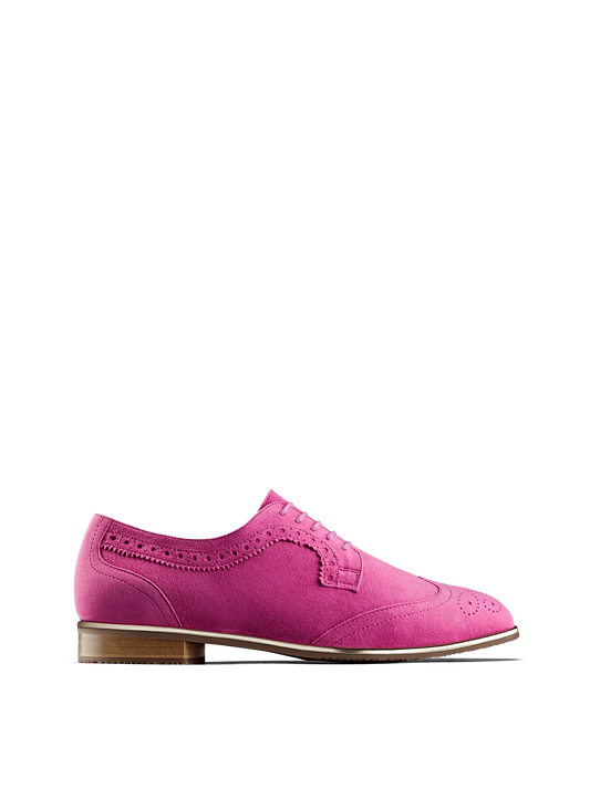 Mullion in fuchsia pink suede, a brogue shoe with a metallic gun metal trim.