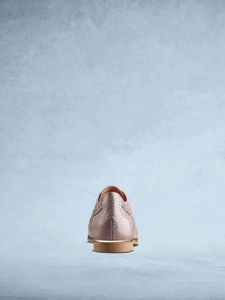 This textured rose gold leather has a contrasting brown sole. 