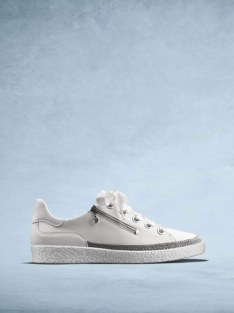 Harlyn is our lace-up white leather trainer with a side zip. 