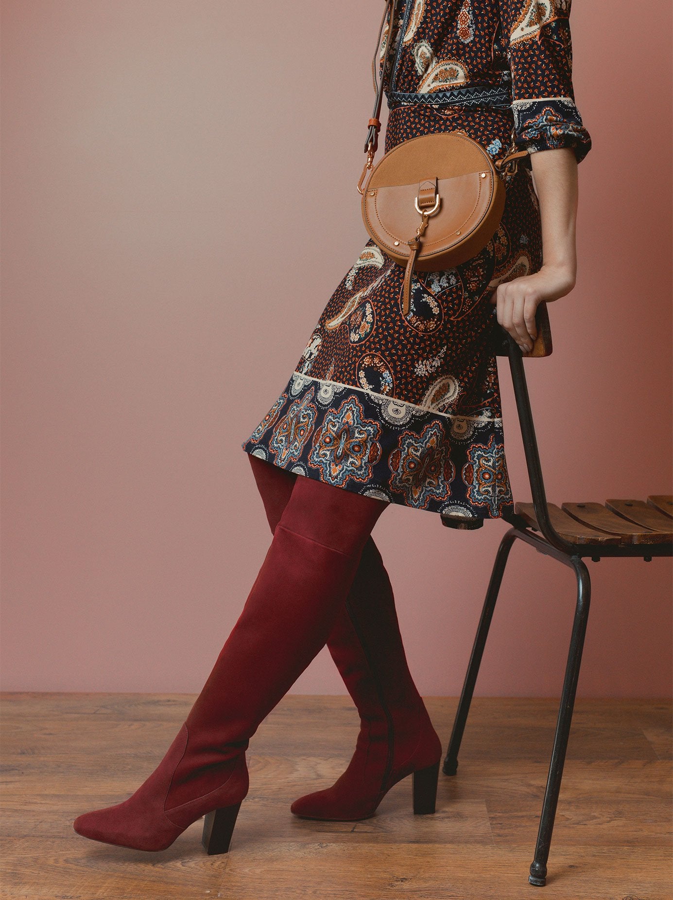 Elegant stitching and turned seams around the black suede ankle. 