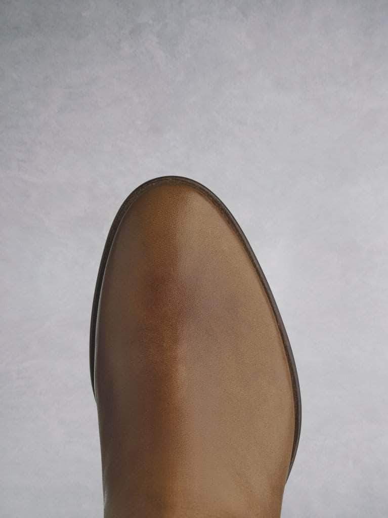 This tan boot has a smooth almond toe shape on a premium-look sole.