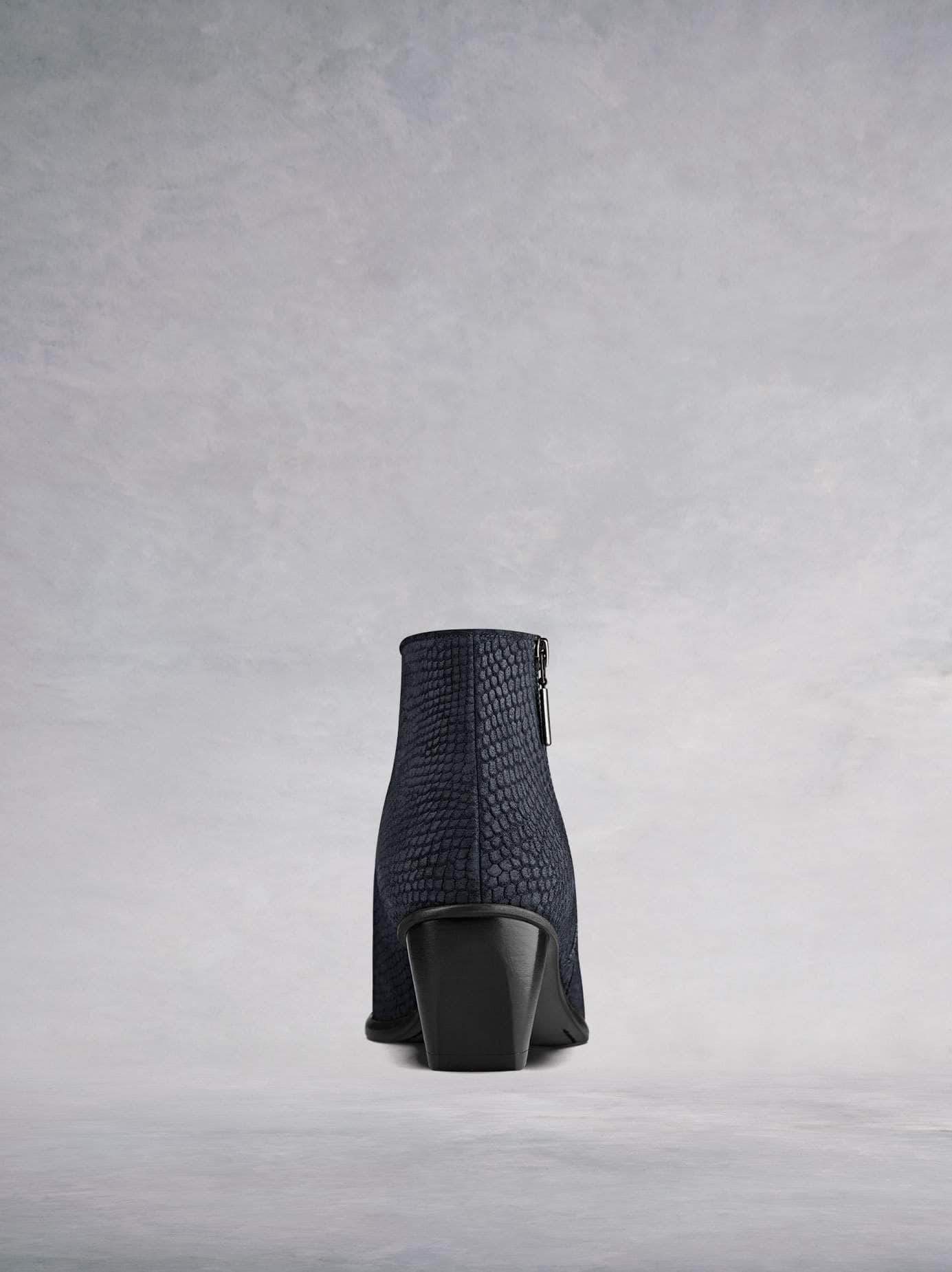 This ankle boot has a complementary bespoke angular shaped block heel in black.