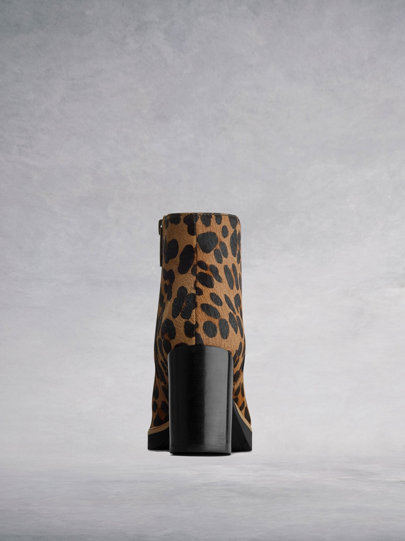 The animal print ankle boot is complemented by a black stacked block heel.