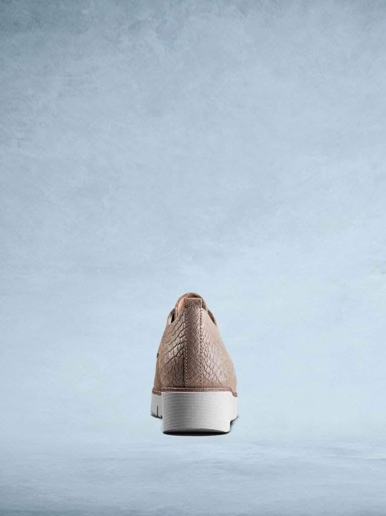 The white platform sole has a sparkly trim detailing.