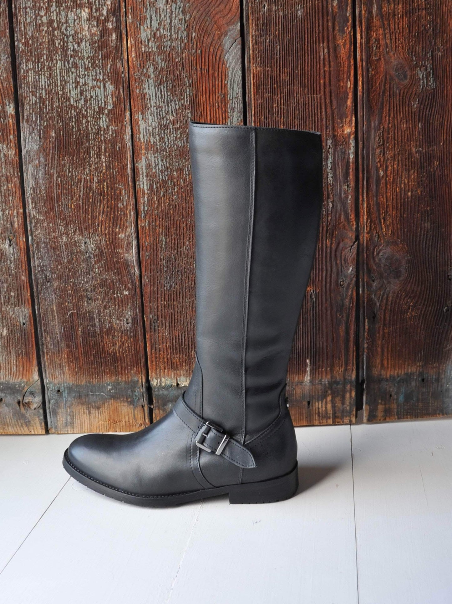 Detailed with a black buckled strap over the neatly cut ankle.