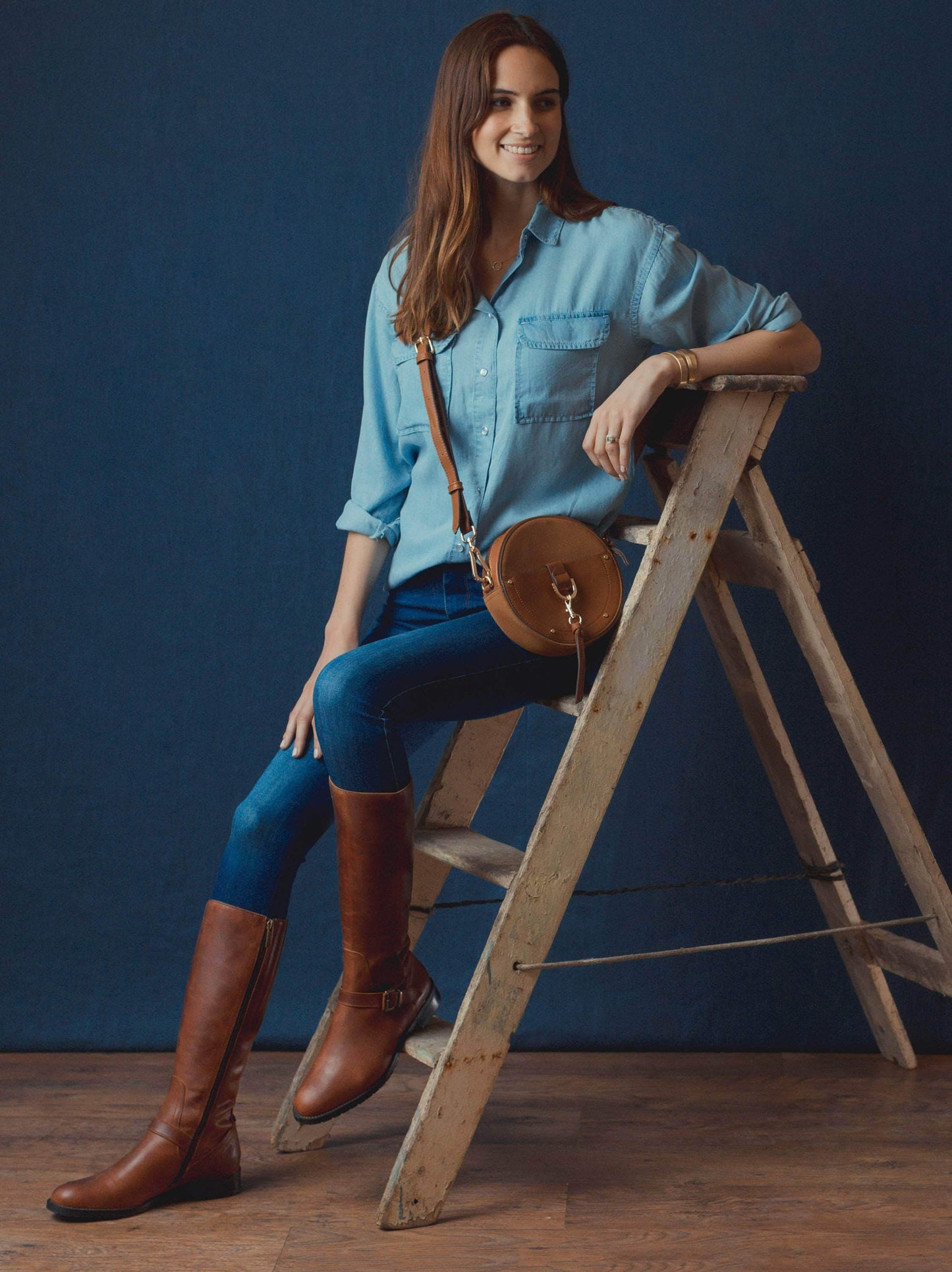 Detailed with a brown buckled strap over the neatly cut ankle.