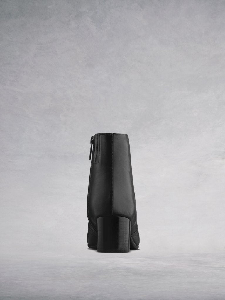 The back features a matching black square shaped low block heel.
