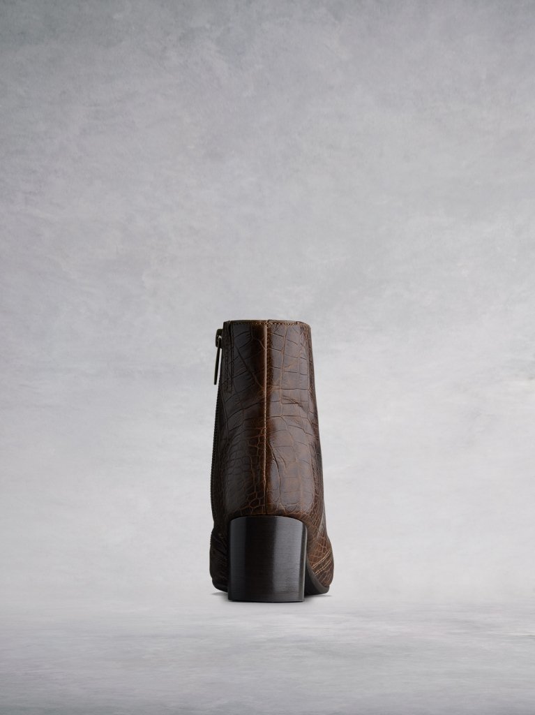 This brown ankle boot features a complementary square shaped low block heel. 